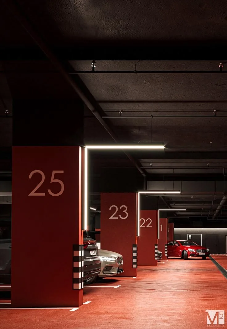 Parking copropriété design avec grands chiffres rouges sur poteaux et sol résine teinté